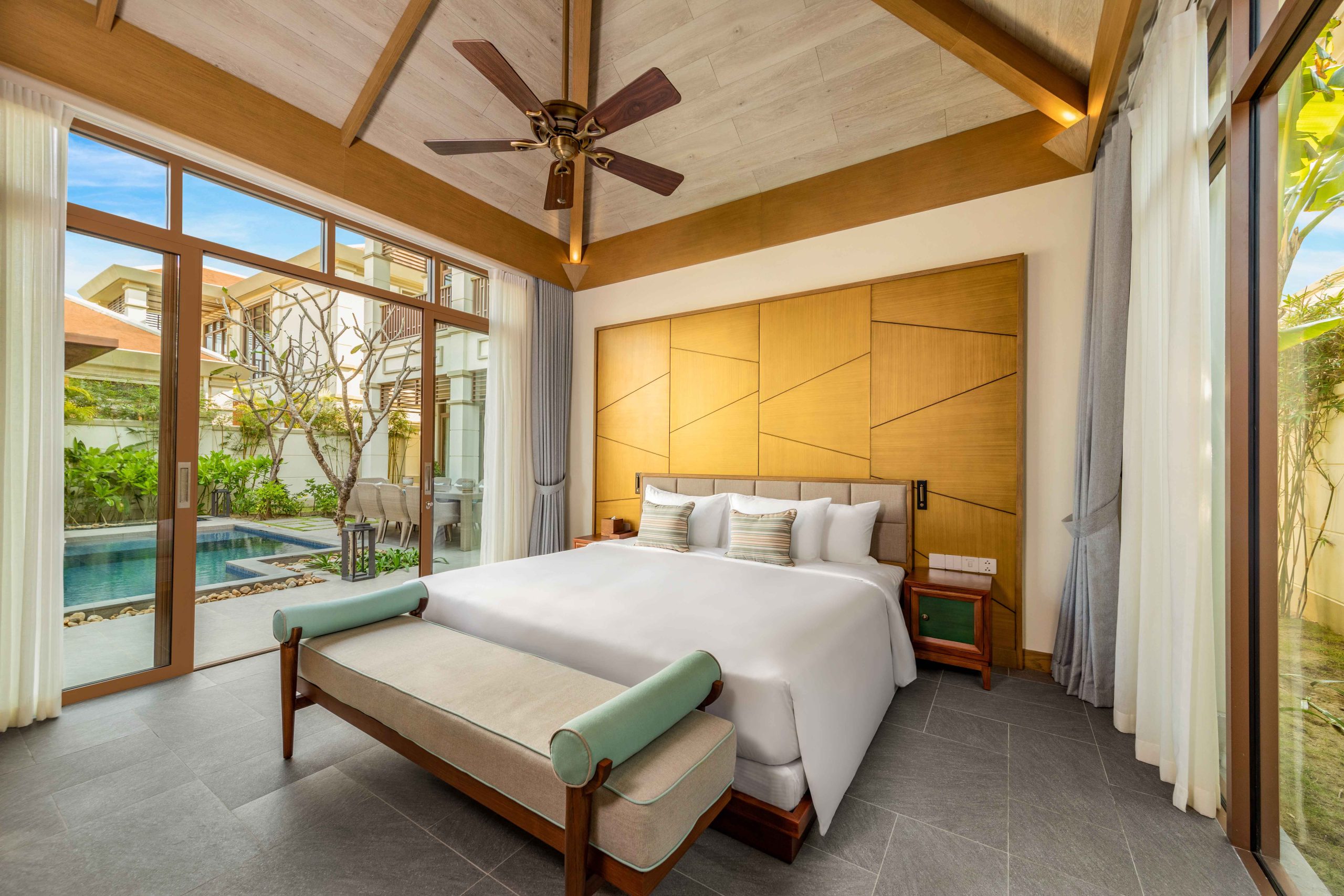 A cosy-looking bedroom of a villa at Fusion Resort & Villas Da Nang