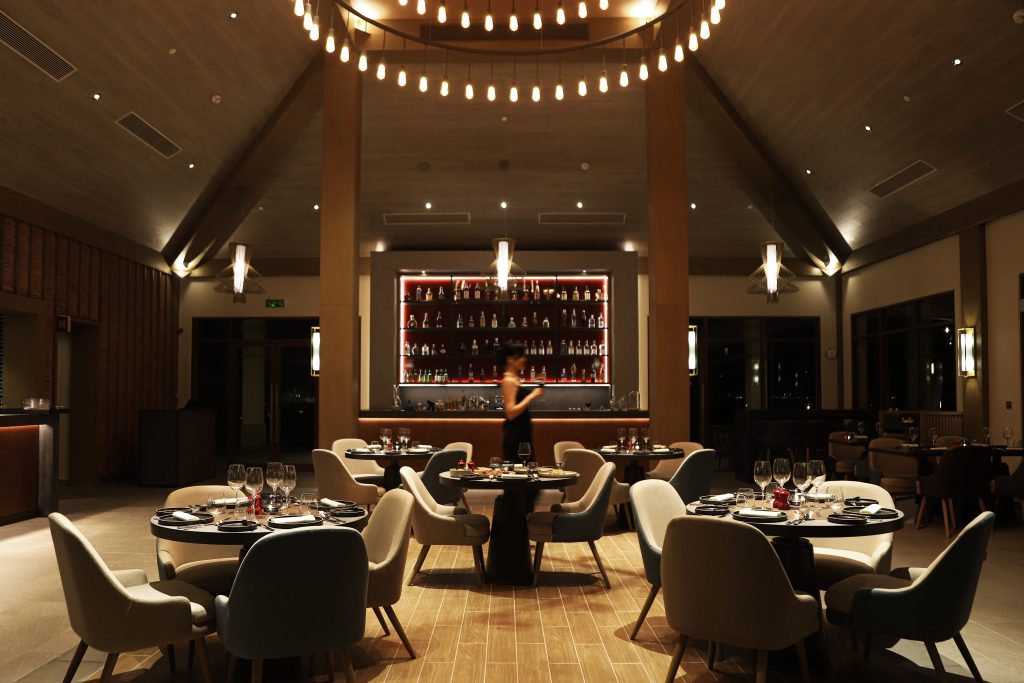 A dimly lit lounge area at Fusion Resort