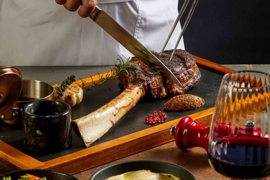 A chef slicing up steak at Fusion Resort