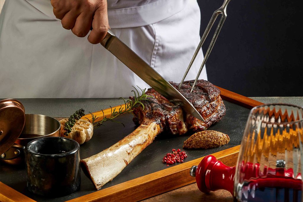 A chef slicing up steak at Fusion Resort & Villas Da Nang