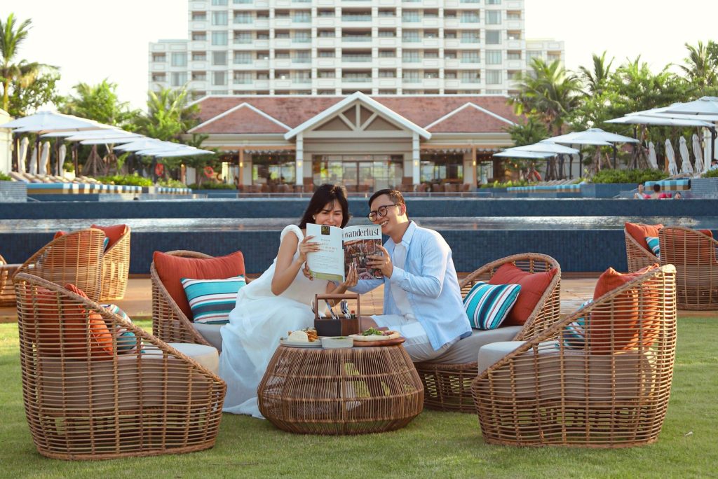 A couple sitting outside reading a menu at Fusion Resort