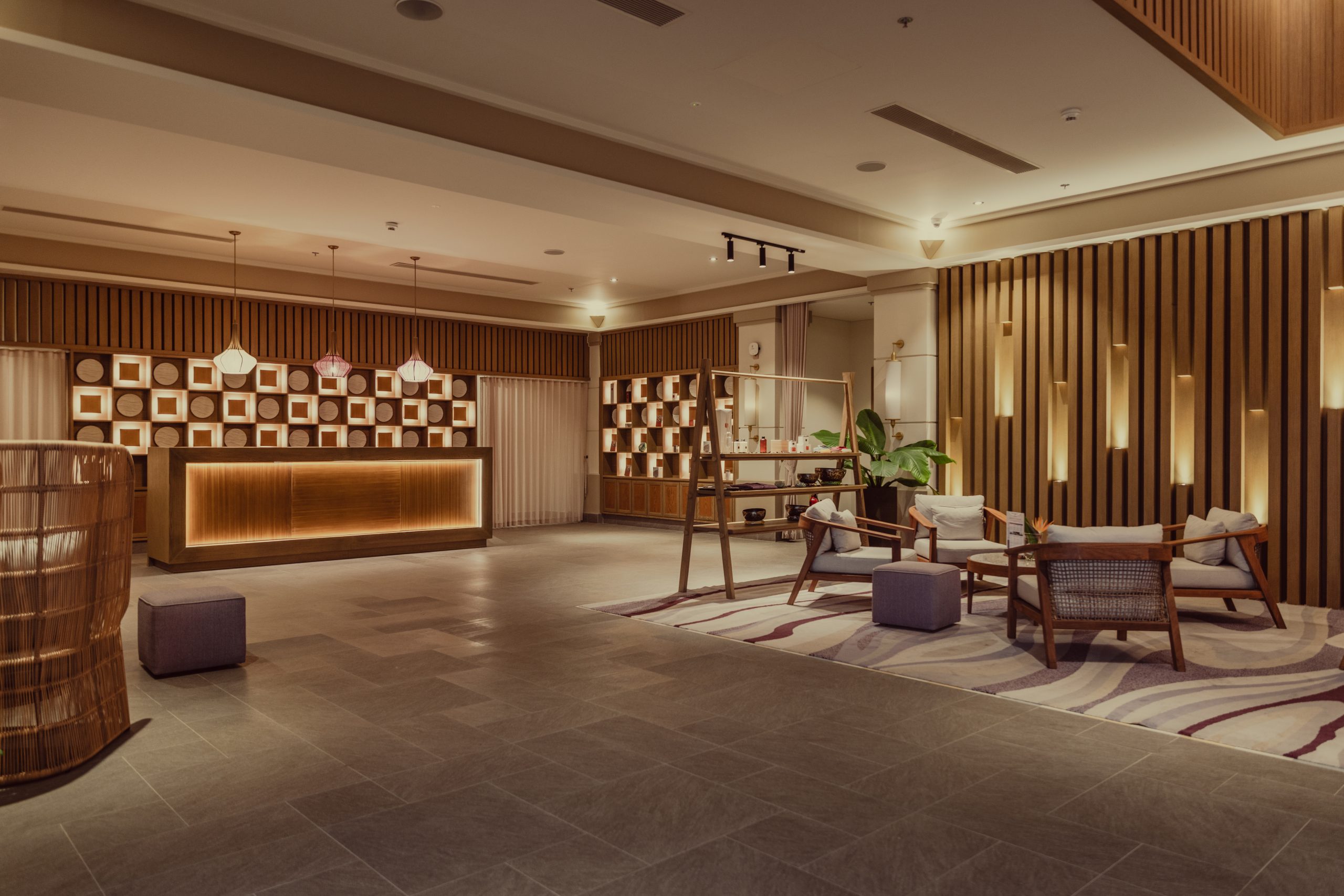 Resort wellness lobby with natural wood interiors and relaxing seating area in Da Nang