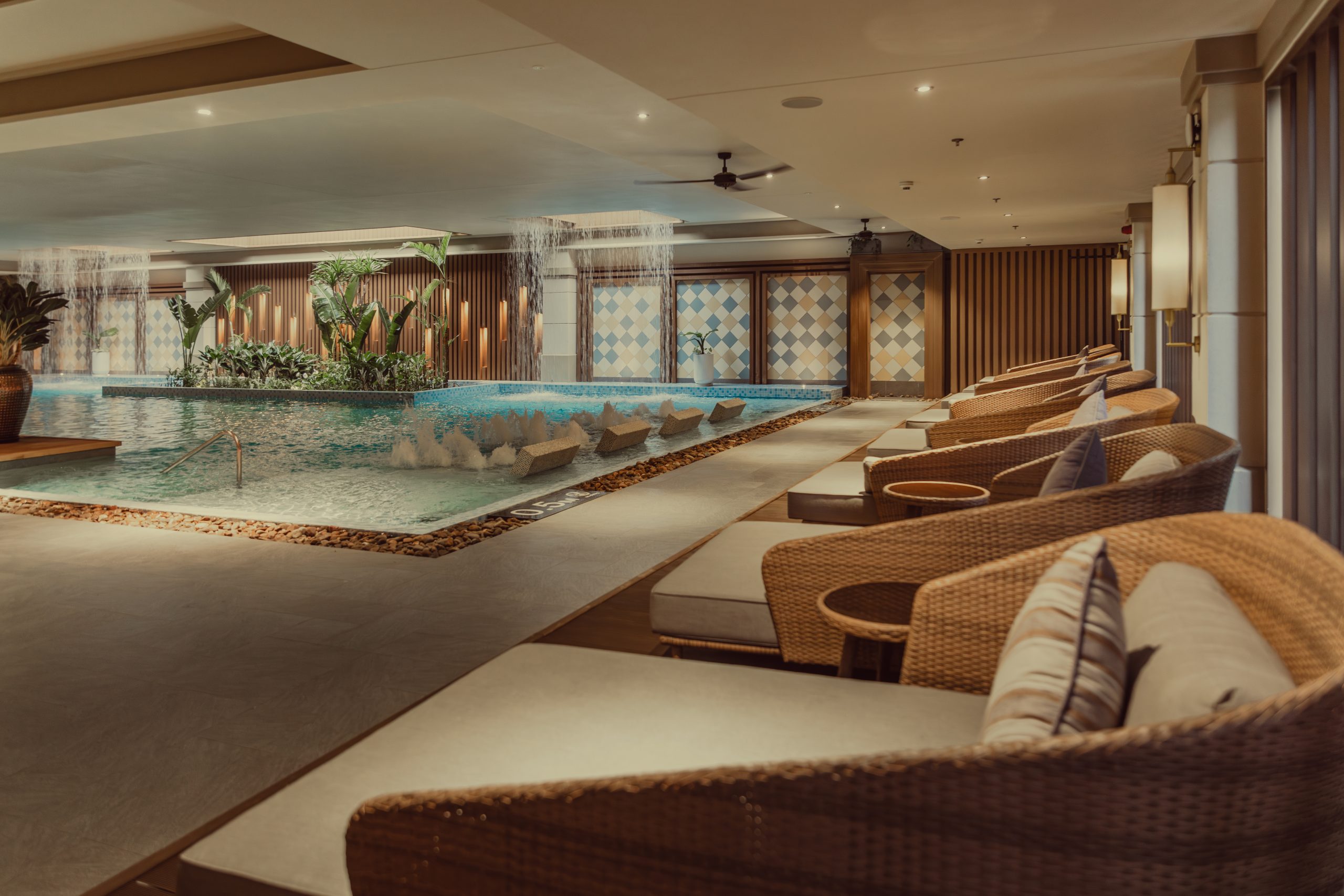 The indoor pool surrounded by comfortable lounge chairs
