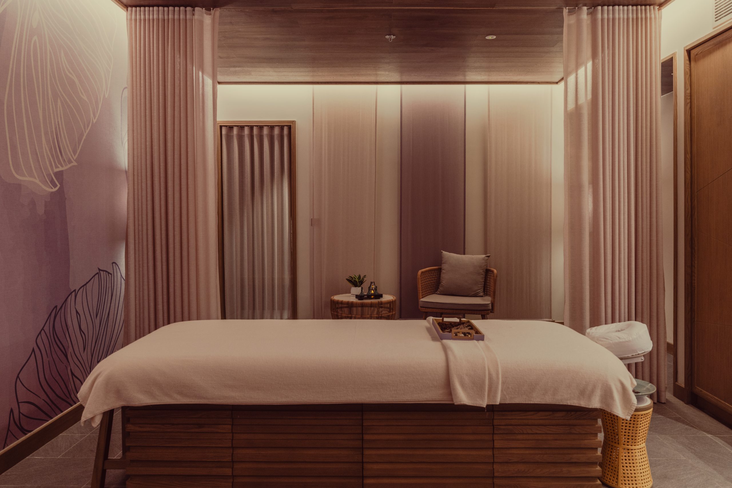 Private spa treatment room at luxury wellness resort in Da Nang, Vietnam with massage bed and tranquil lighting